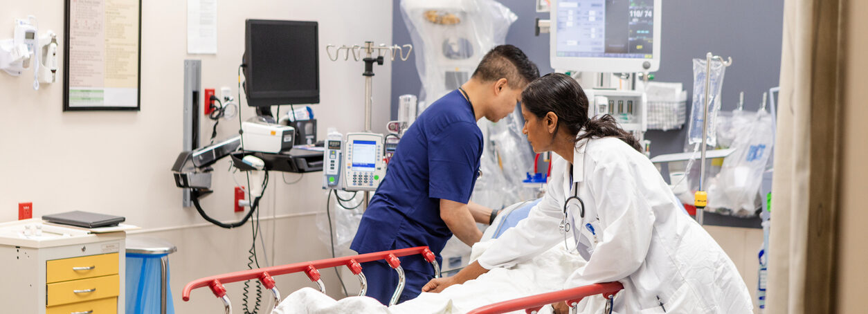 ER doctor and nurse prepare unconscious woman for examination
