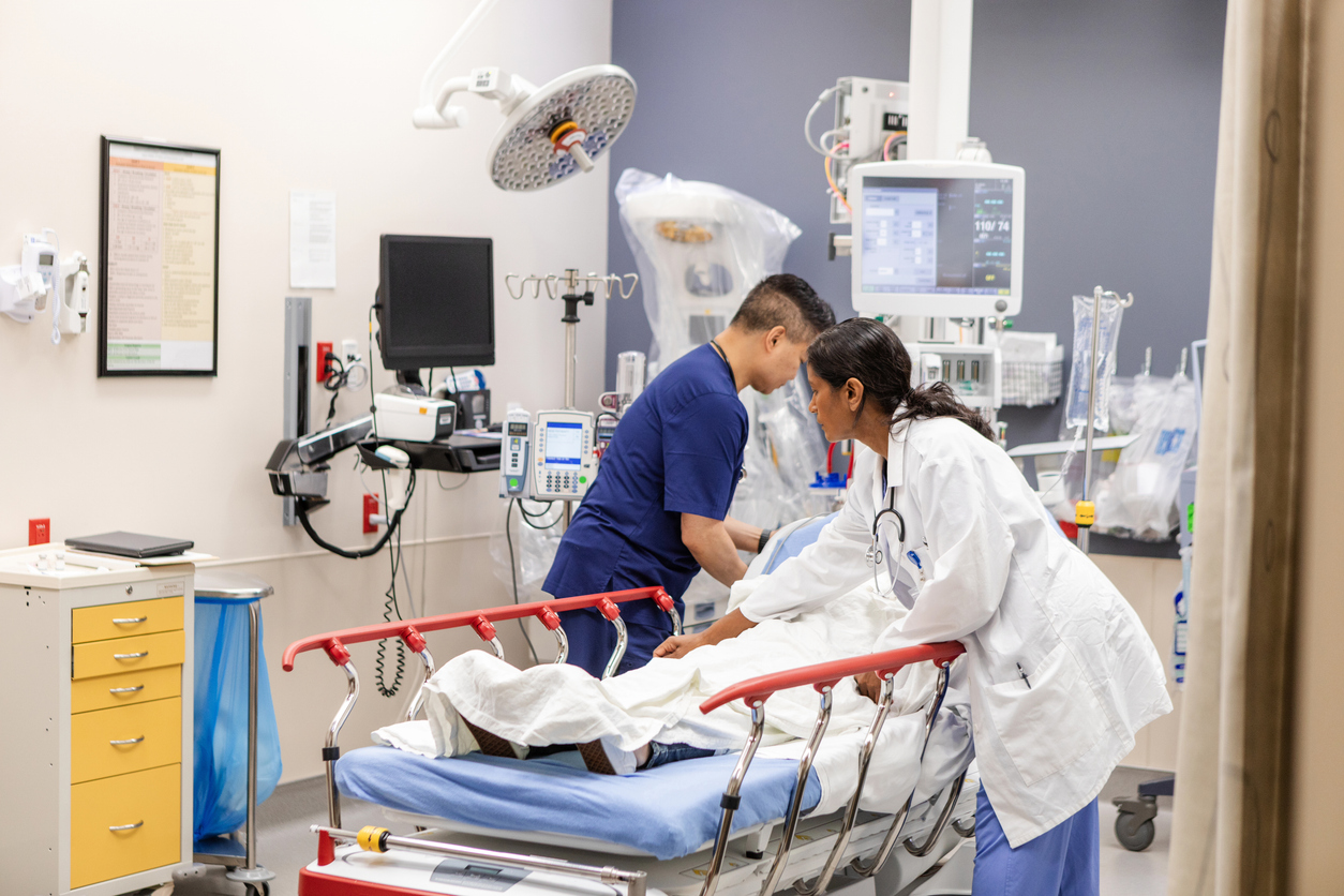 ER doctor and nurse prepare unconscious woman for examination