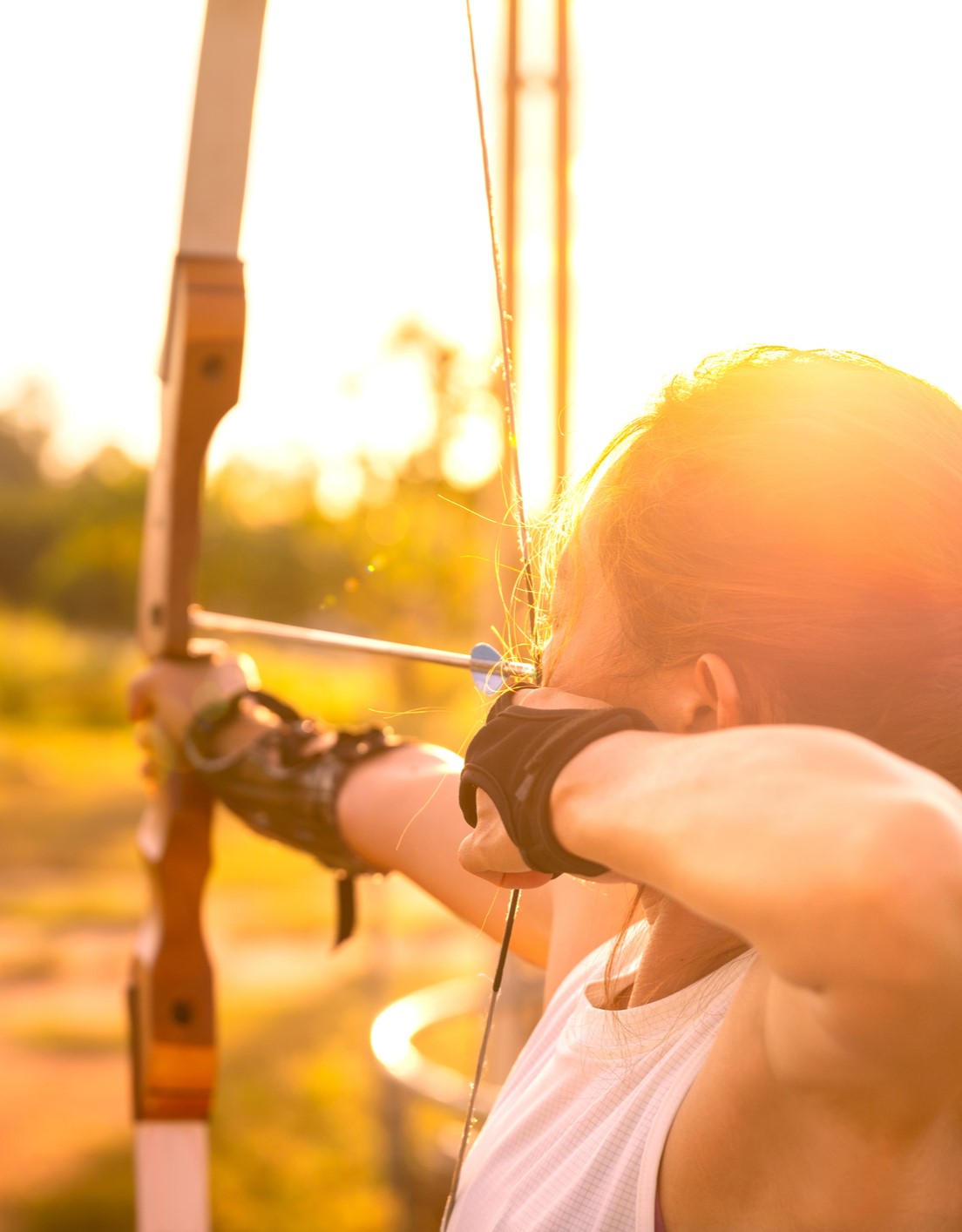 Girl shooting bow and arrow iStock mobile crop