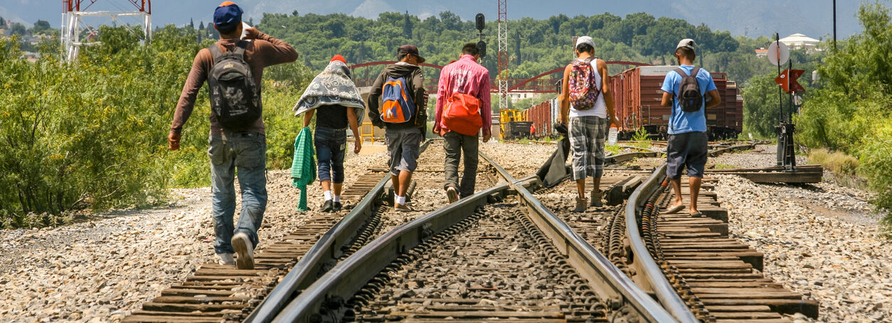 A group of migrants walk along the railroad near the US Mexico border in the state of Coahuila in northern Mexico