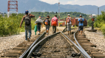A group of migrants walk along the railroad near the US Mexico border in the state of Coahuila in northern Mexico