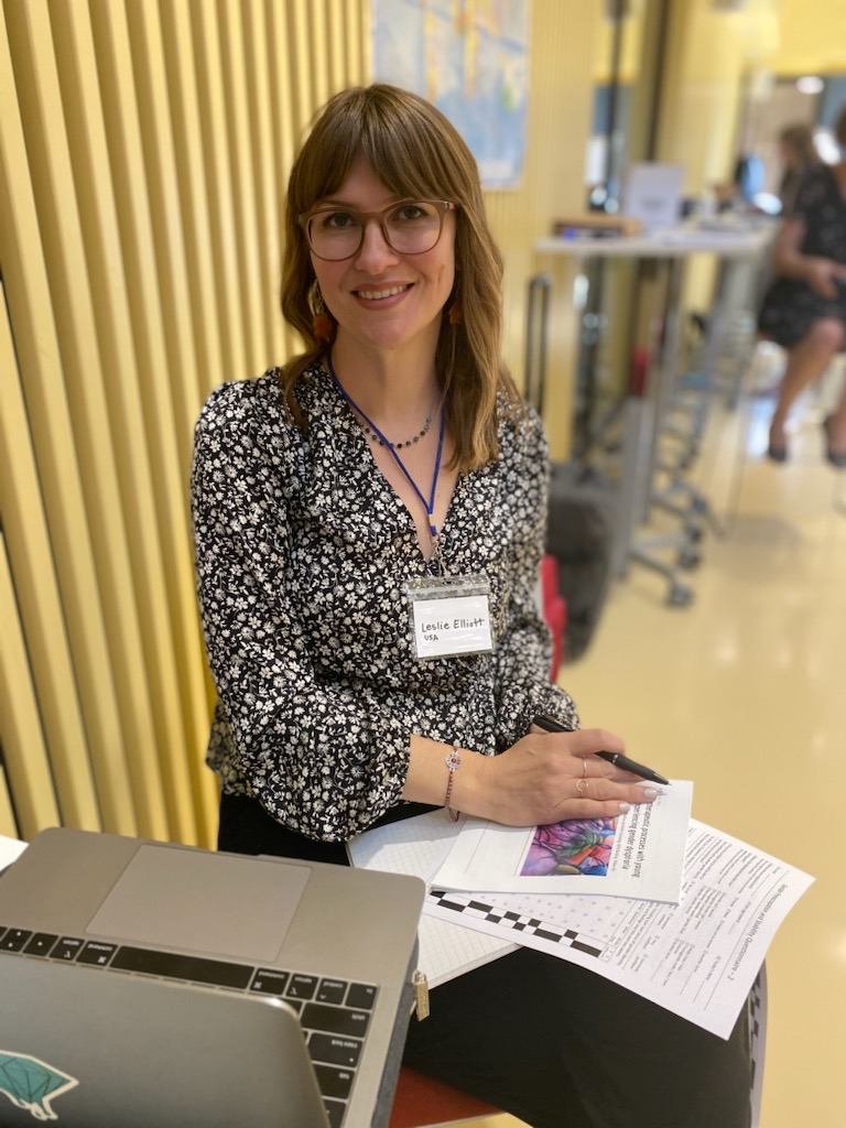 Leslie Boyce taking notes and writing at an event