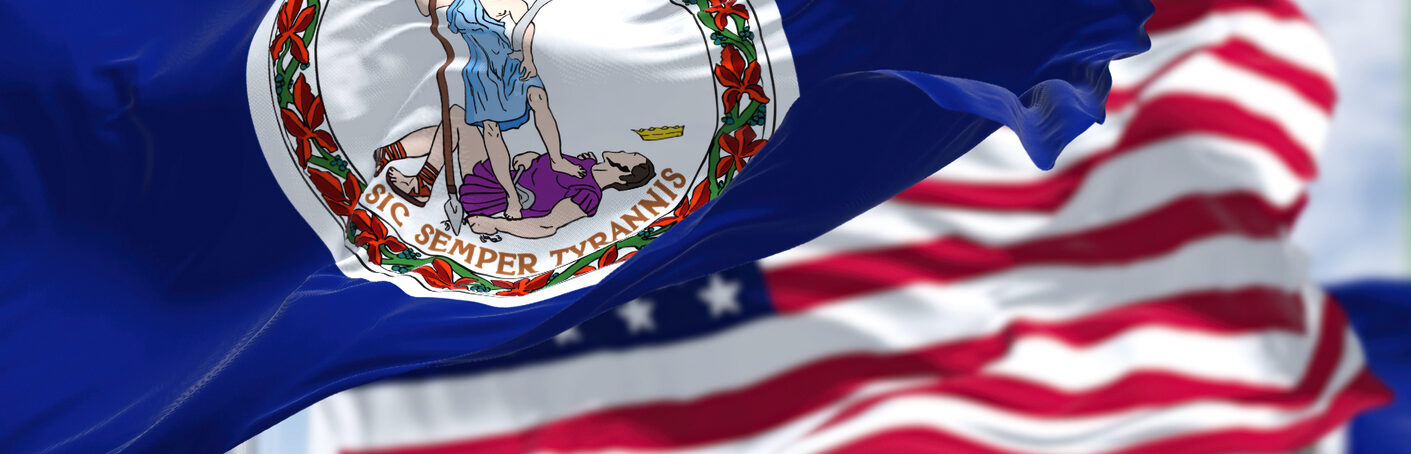The Virginia state flag waving along with the national flag of the United States of America