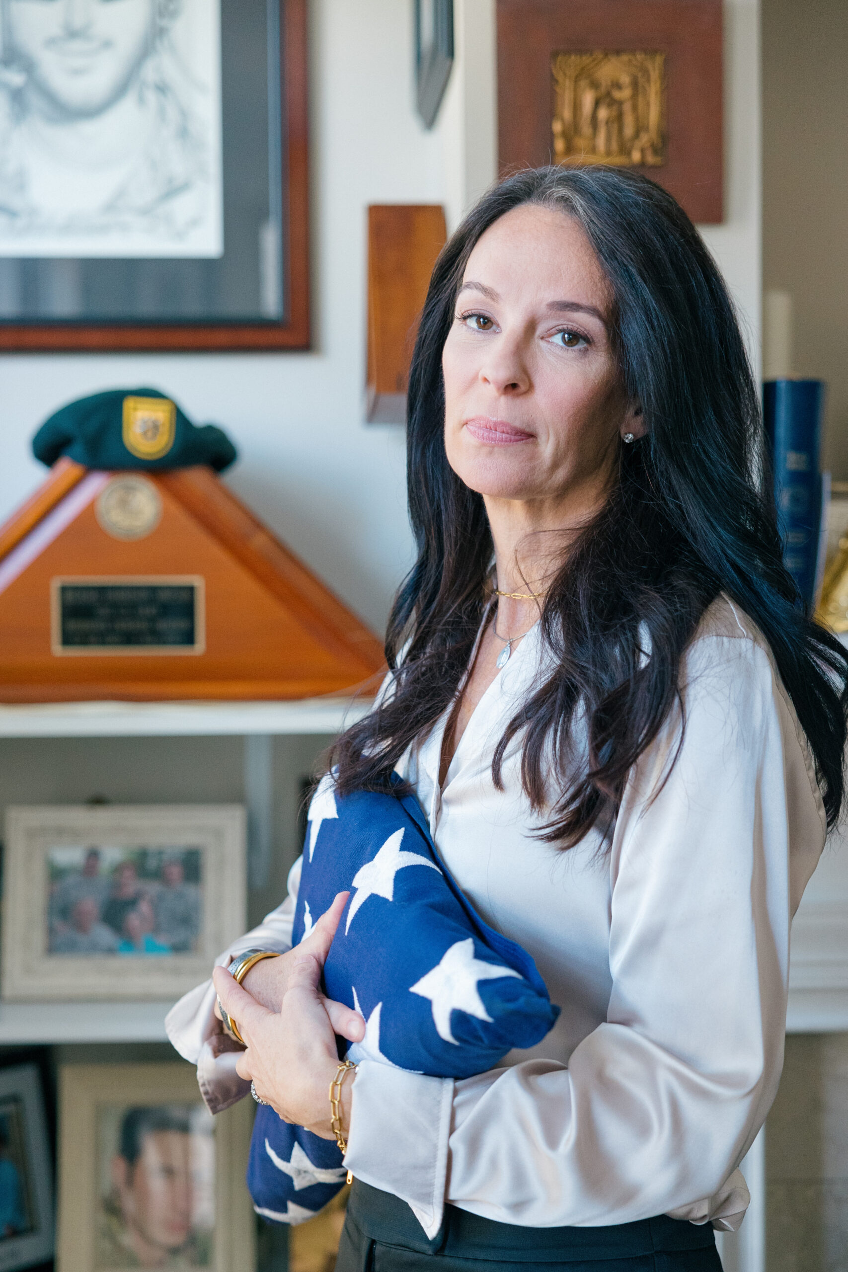 Krista Simpson Anderson holds her husband's service flag in her Virginia home