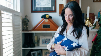 Krista Simpson Anderson holds her husband's service flag