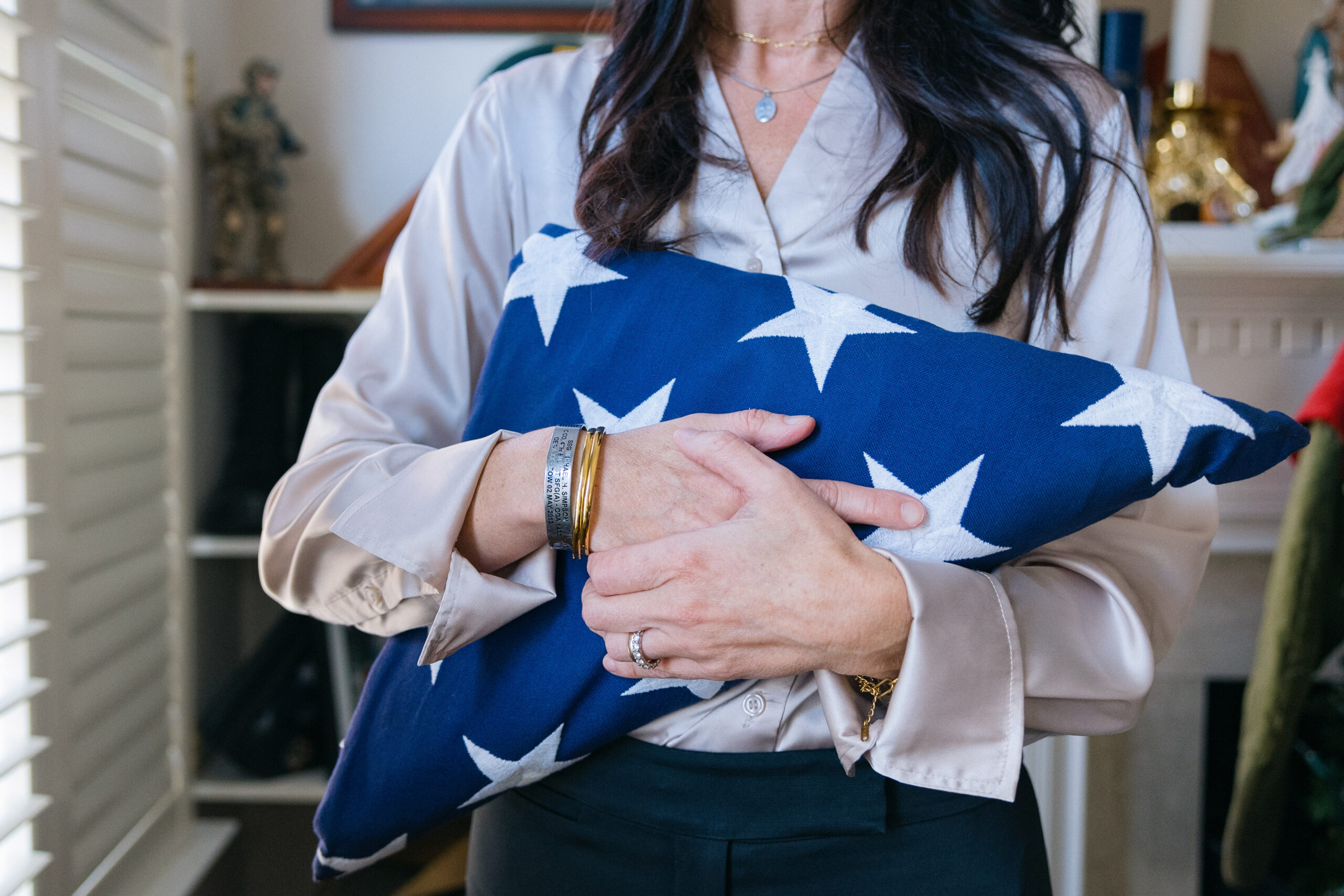 Anderson holds her husband's folded service flag