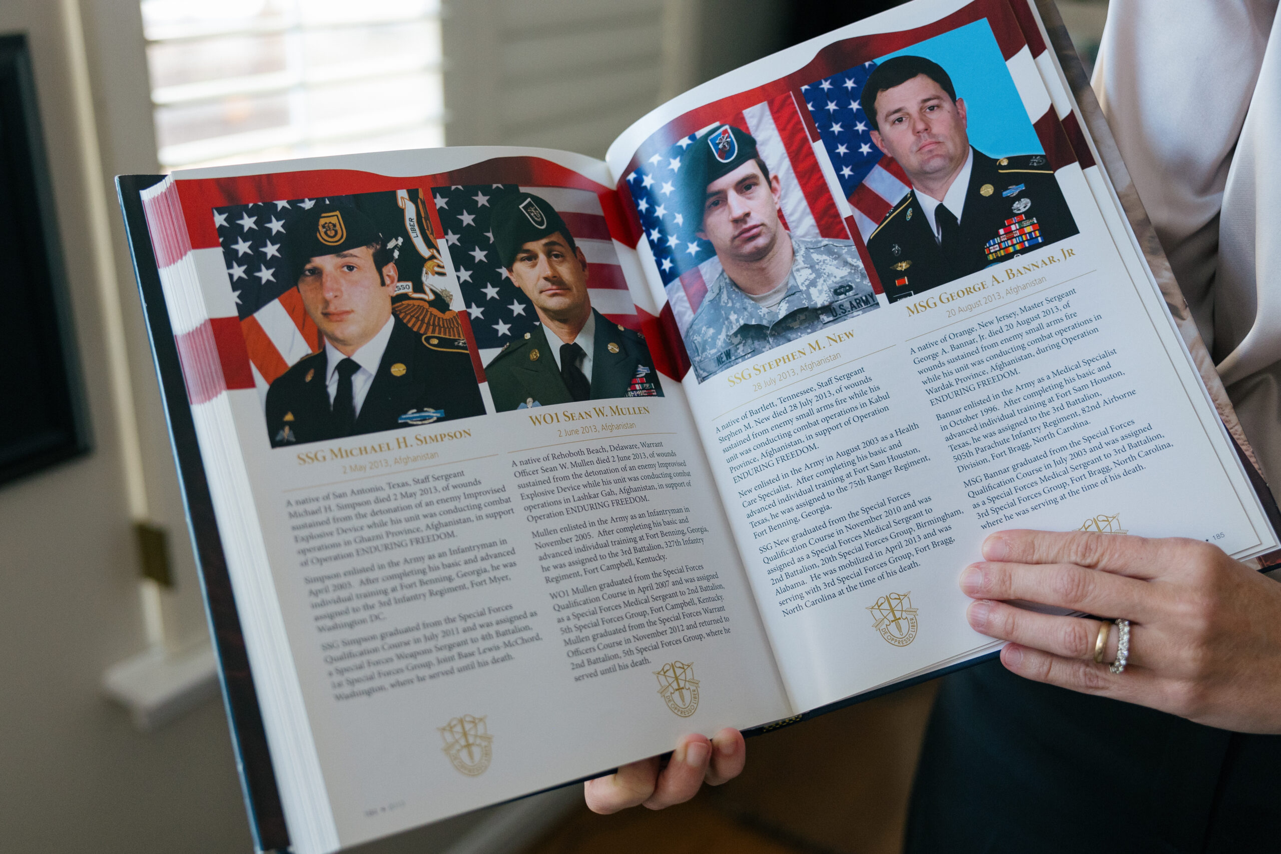 Krista Simpson Anderson showcases the book, "The Last Full Measure of Devotion," a tribute to U.S. Army Special Operations Forces who died in service from 2001 to 2014.