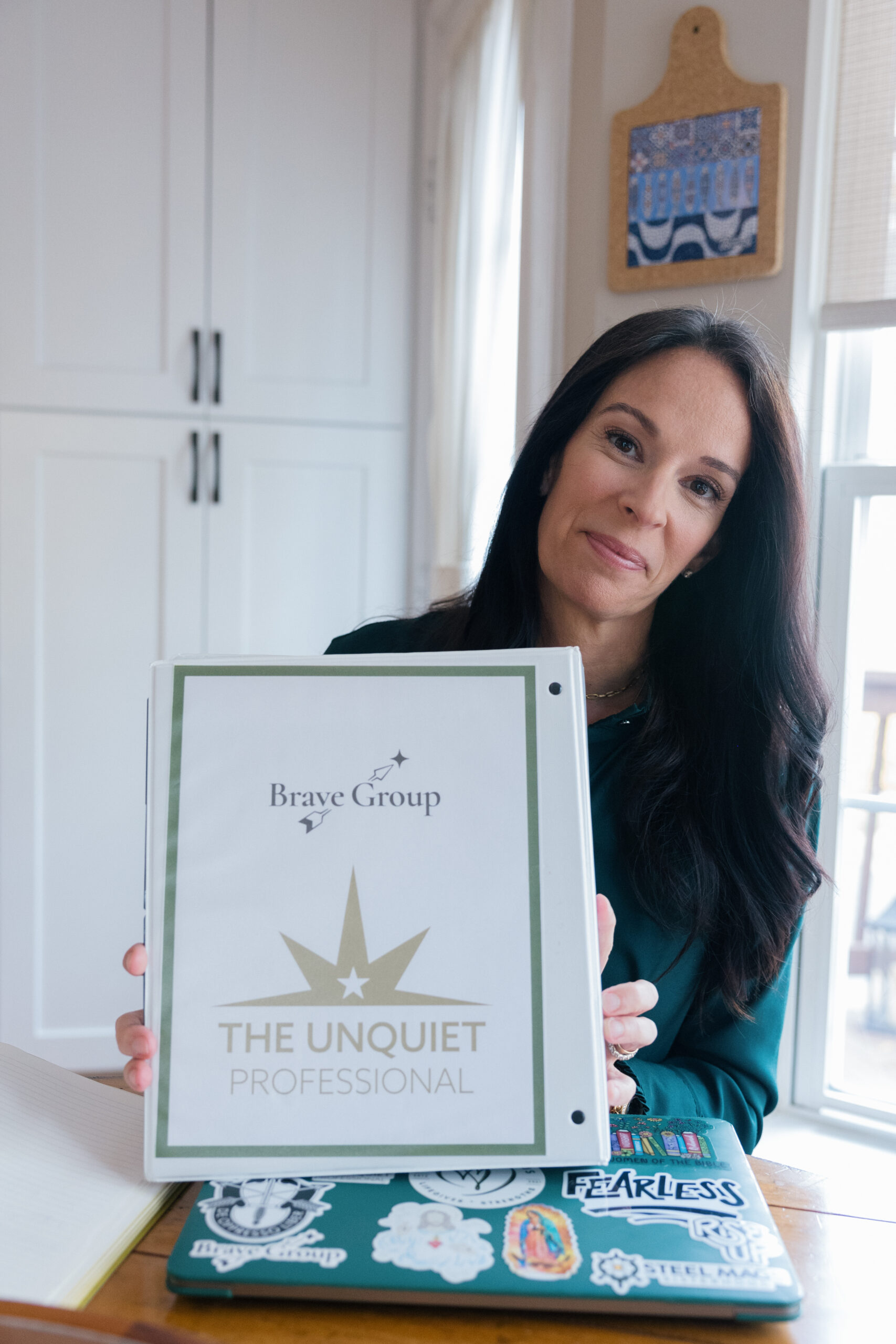 Anderson holds materials from the Unquiet Professional's program to protect one's legacy