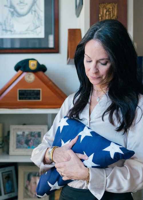 Krista Simpson Anderson holds her husband's service flag