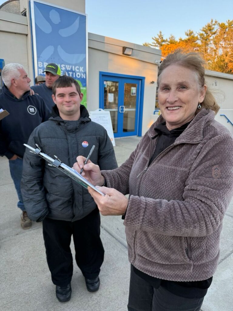 Woman signing Maine Girl Dads' petition