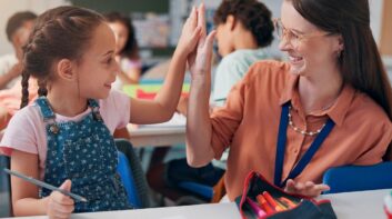 Student high fiving teacher