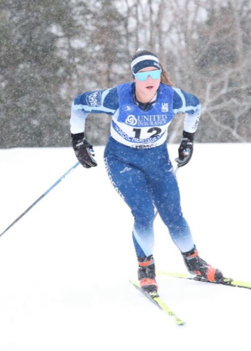 Cassidy Carlisle cross country skiing in a snow storm