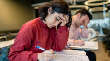 Stressed teenage girl studying