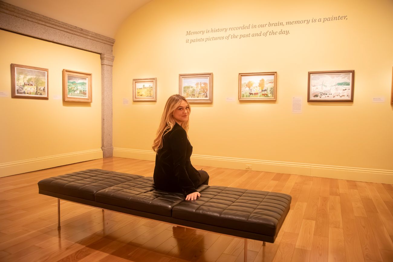 Isabel Brown looking over her shoulder sitting on a bench