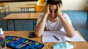 Student frustrated staring at a COVID mask