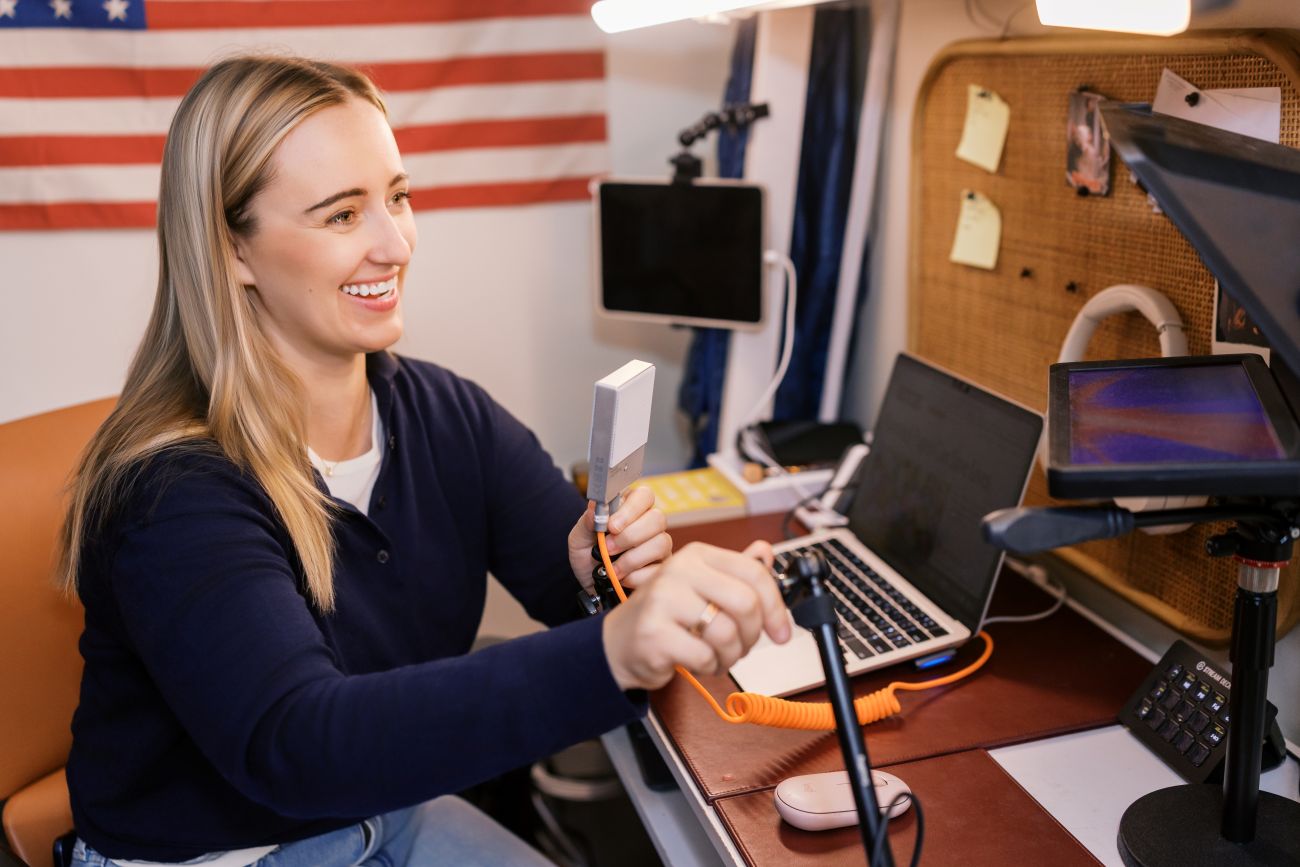 Emily Jashinsky sitting at her in home studio