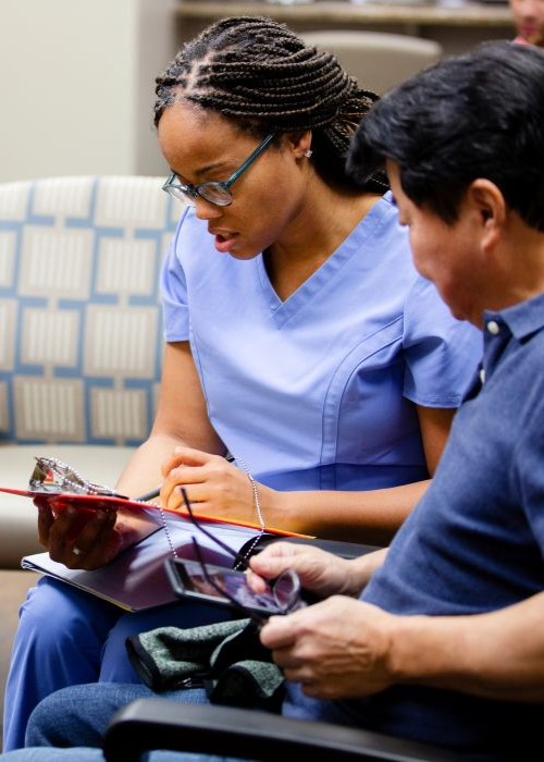 Health care worker talking with patient in waiting room