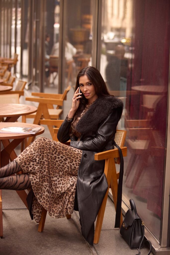 Hugoboom sits outside a cafe in NYC