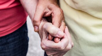 Two women holding hands