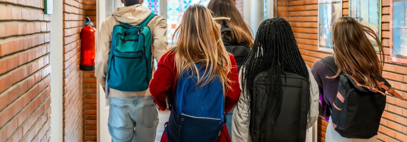 High school students walking through a school hallway
