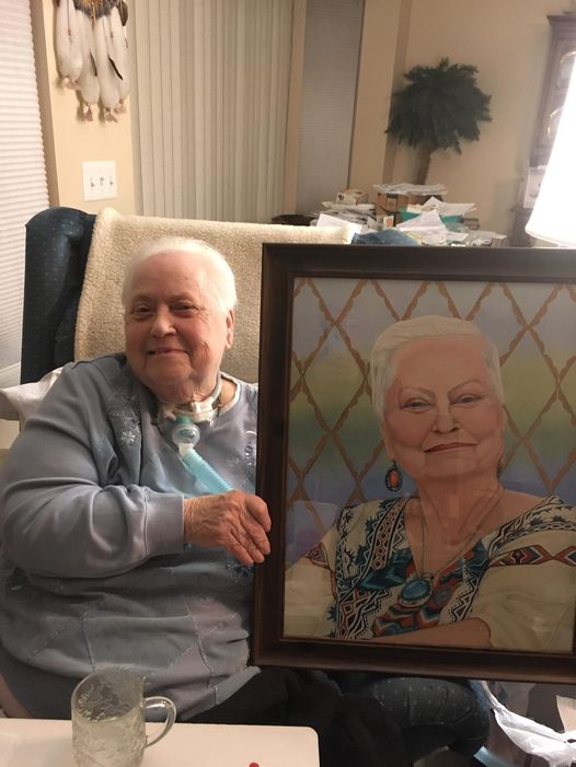 Judy with her portrait in 2022