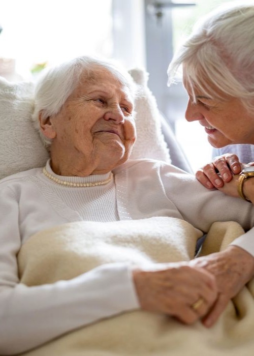 Woman caring for her elderly mother