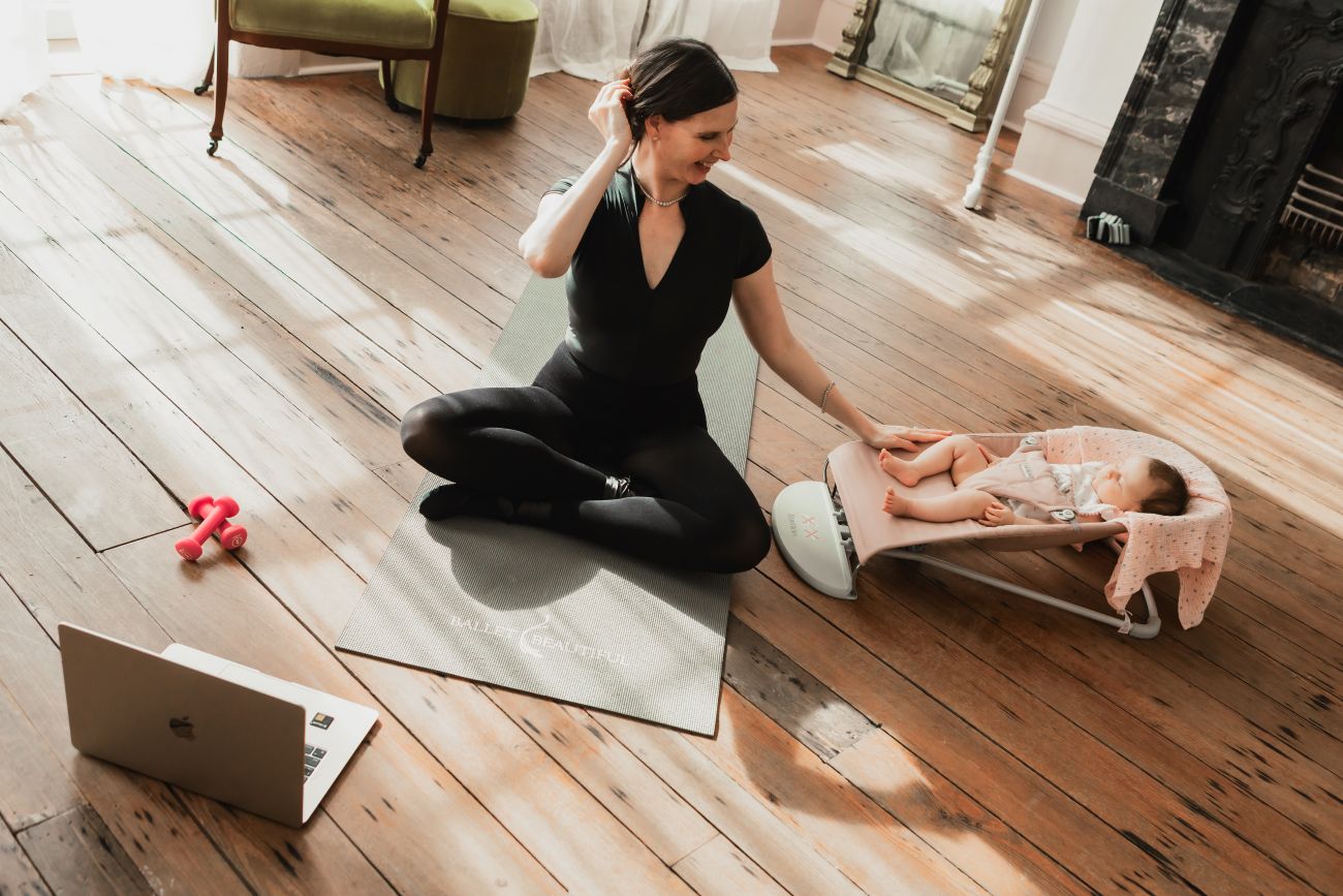 Bowers doing Ballet Beautiful with her baby daughter nearby