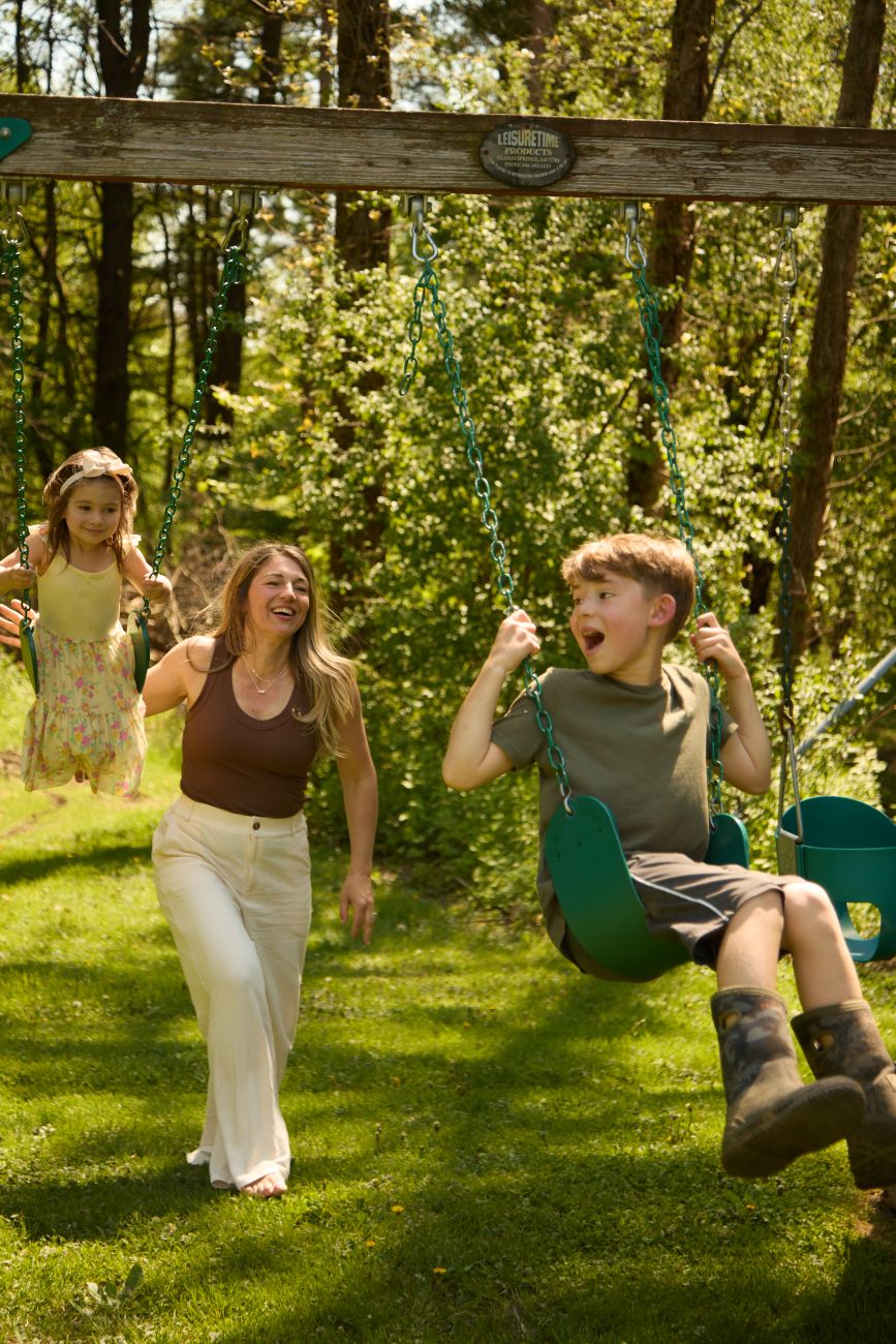 Cheryl Daley and her children on swingset
