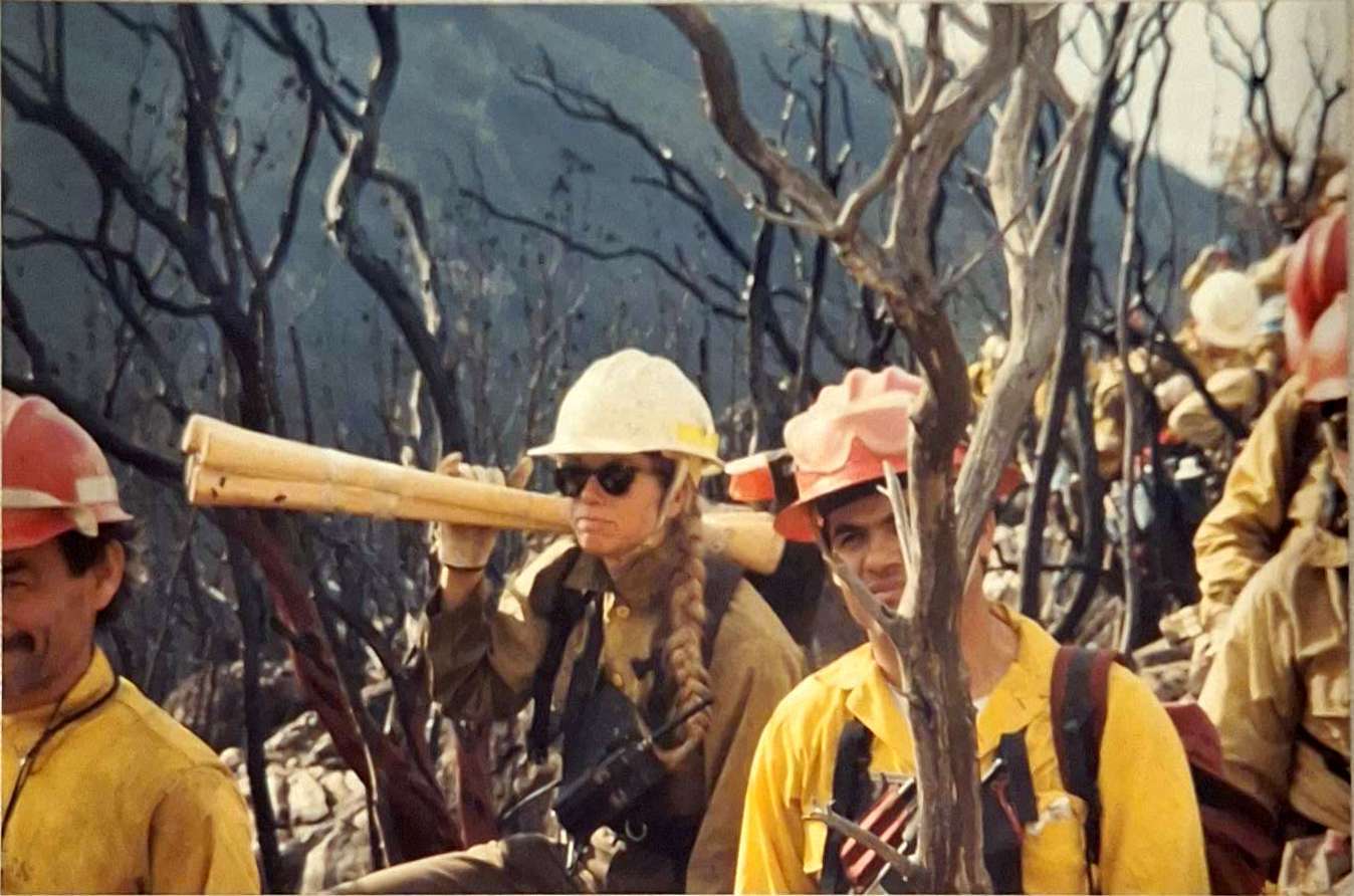 Denise Lever carrying firefighting axes