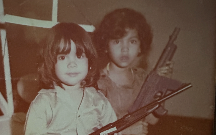 Judy Pino as a child with a rifle featured image