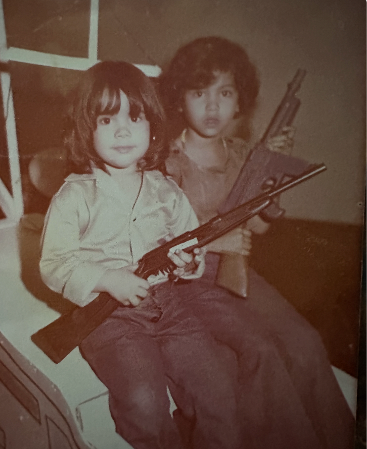Judy Pino as a child with a rifle