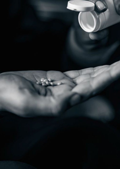 Woman holding pills and pill bottle mobile