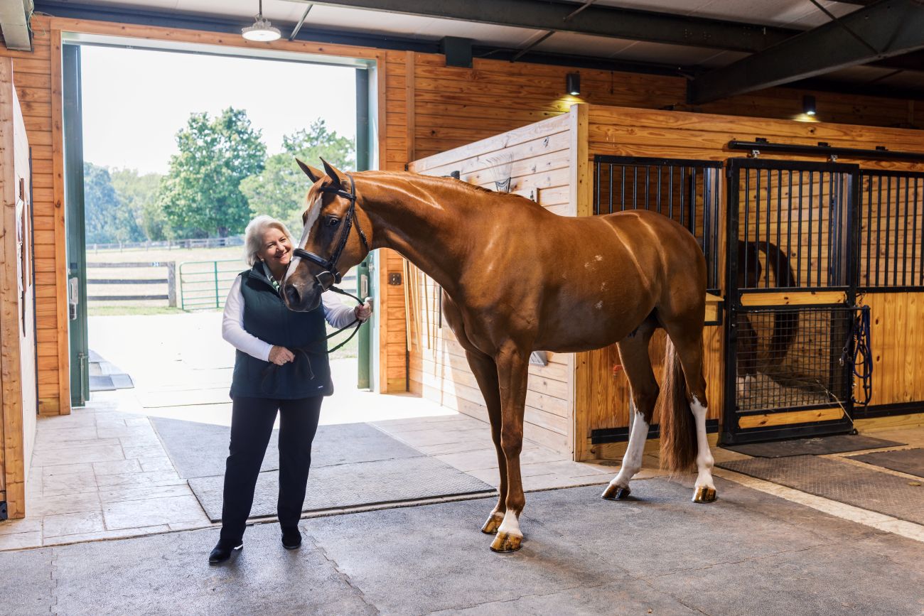 Mary Pope Hutson and horse in the stables