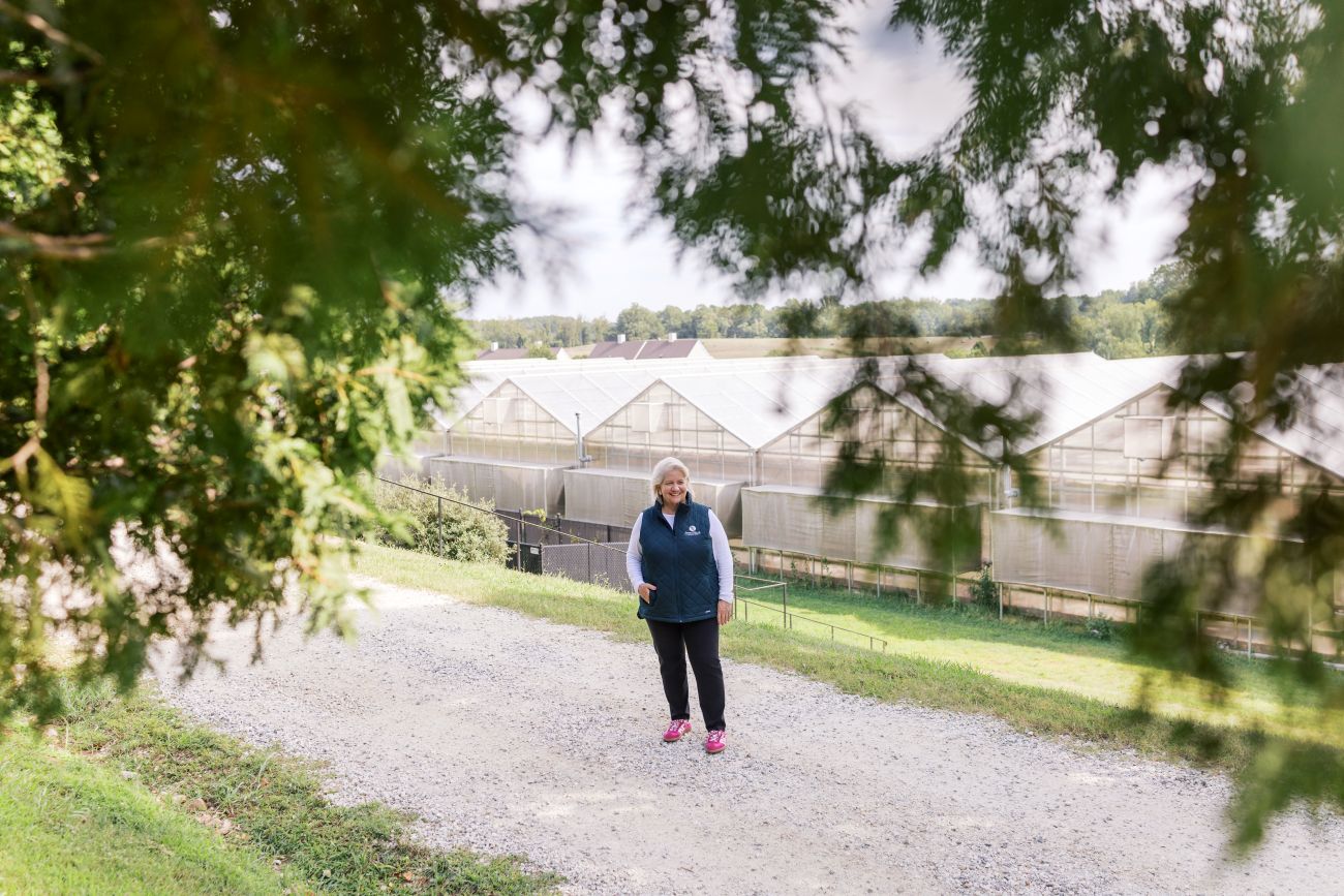 Mary Pope Hutson by Sweet Briar's greenhouse