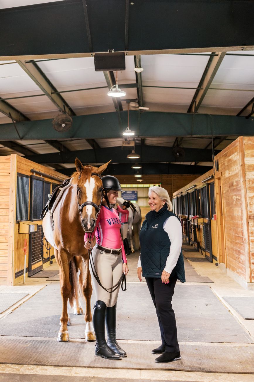 Mary Pope Hutson with students in Sweet Briar's stables