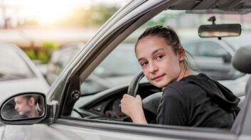 Teenage girl driver backing out of a parking spot