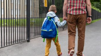 Father walking his son to school