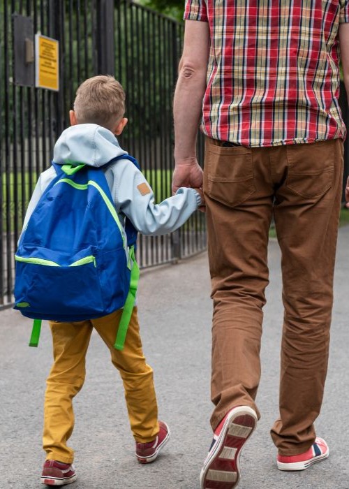 Father walking his son to school