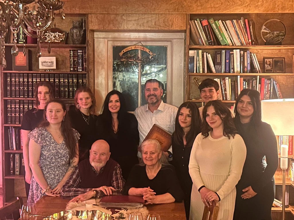 Katie and Doug with their seven children and Katie's parents at their farm in rural Kansas