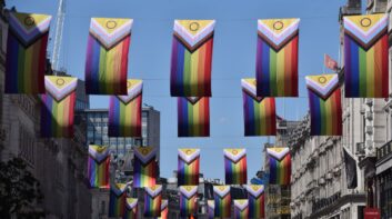Pride flags overhead a street